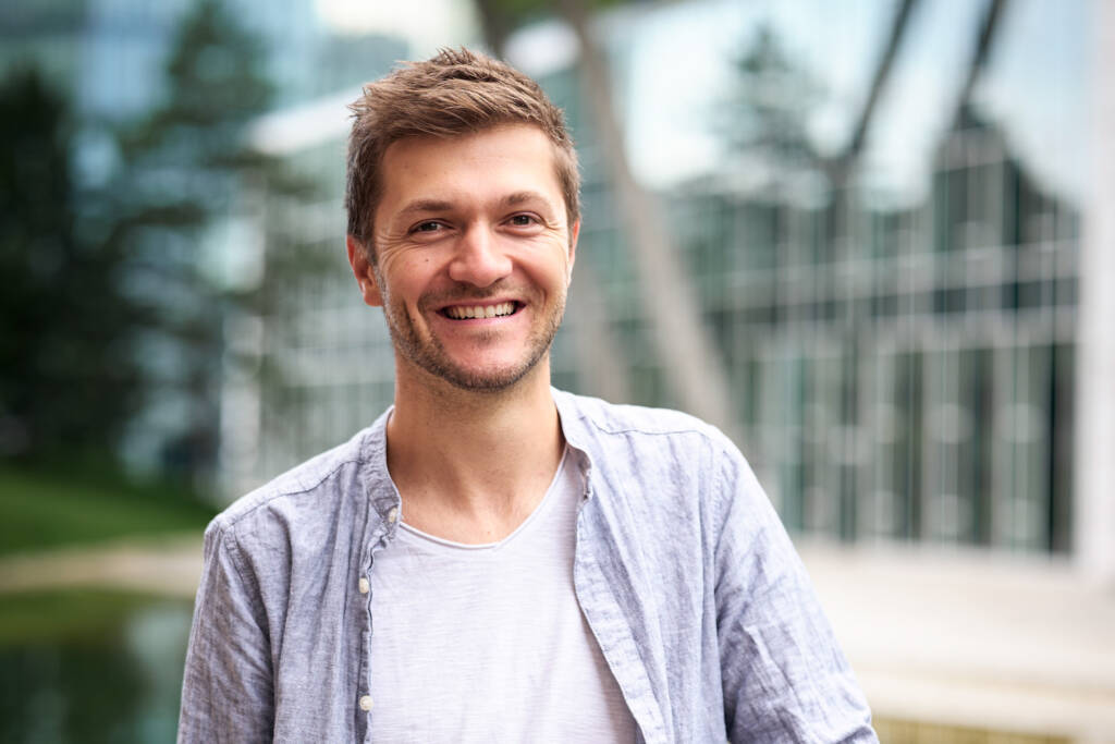 Profilfoto von Philip Pürcher mit weißem Shirt und Jeans Hemd, lachend blickt er in die Kamera